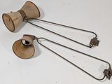 two old fashioned wooden bells are sitting on a white surface