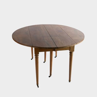 an image of a wooden table with four legs and a round top