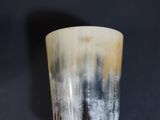 a close up of a silver cup on a black surface