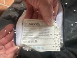 a person holding a piece of cloth with pearls on it