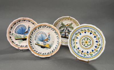 four plates with different designs on them sitting on a gray surface
