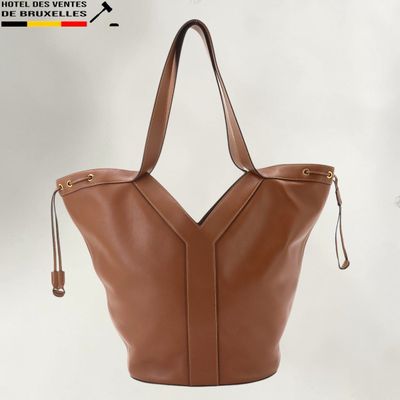 a brown leather tote bag on a white background
