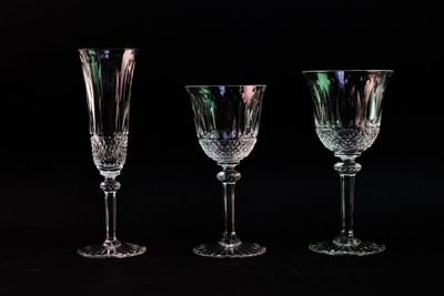 three empty wine glasses are lined up against a black background
