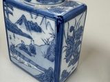 two blue and white vases sitting next to each other on a table