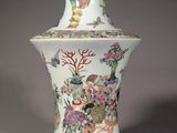 a vase with a painting on it sitting on a table