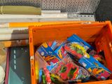 a orange box filled with assorted items on the floor