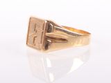 an image of a gold signet ring on a white surface