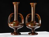 two vases that are sitting on a white table
