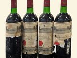 three bottles of red wine are lined up on a table