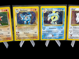 four pokemon cards are lined up in a row on a black background