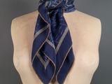 a close up of a mannequin torso with a scarf on it