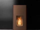 a brown fireplace sitting on top of a cement floor next to a black wall