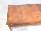 a small wooden table with a drawer on top of it