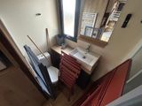 a bathroom with a toilet, sink, and mirror in it