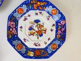 a blue and white plate with a picture of a monkey on it