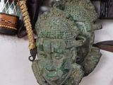 a close up of a statue of a person with a hat on