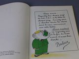 an open book with a picture of an elephant in a green suit