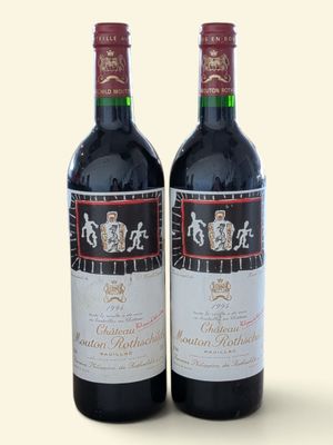 two bottles of wine sitting next to each other on a table
