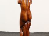 an image of a wooden statue of a woman standing on a pedestal