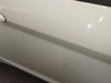 a close up of a car door handle with a sticker on it
