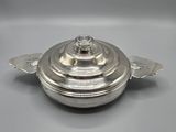 an antique silver plated casserole dish with a domed lid