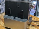 a toaster sitting on a wooden table in a kitchen
