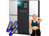 the woman is standing next to a digital scale with batteries on it