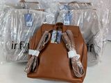 three bags of luggage that are wrapped in plastic
