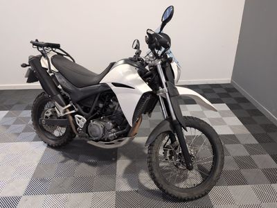 a motorcycle that is parked on a checkered floor