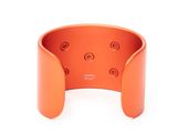a close up of an orange cuff bracelet on a white background