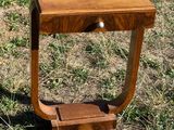 a small wooden table with a drawer in the middle of it