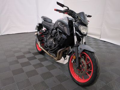 a black and red motorcycle parked on a black and white checkered floor