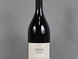 a bottle of red wine sitting on a table