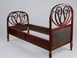 an image of a bed with a wooden frame and a metal headboard
