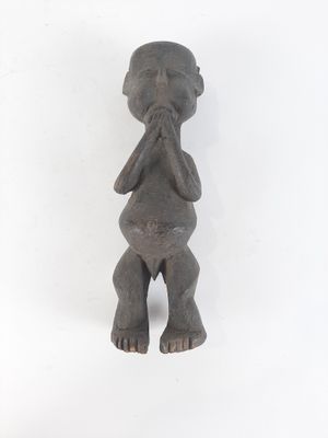 figurine of a man with hands in his mouth