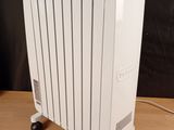 an electric radiator sitting on top of a wooden table next to a black wall