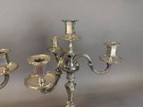 a silver candelab with three candles on top of it
