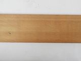 a close up of a piece of wood on a white surface