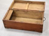 a small wooden box with a lid open on a white surface