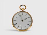a gold pocket watch with roman numerals on the face