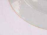 a close up of a white plate with a fork and knife on it