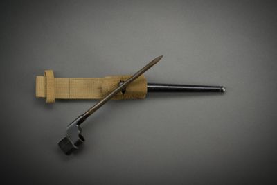 a knife that is laying on top of a piece of wood