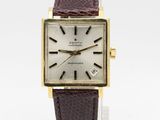 a close up of a wrist watch with a brown leather strap