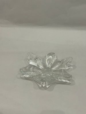 a snowflake that is sitting on a white surface