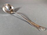 a silver spoon with a spoon handle on a table