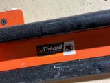 a close up of an orange bench with a sticker on it