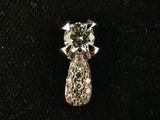 a close up of a diamond pendant on a black surface