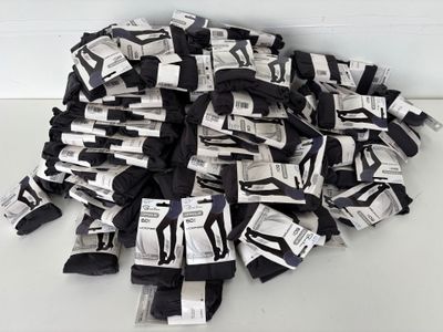 a pile of black and white socks on a white table