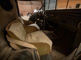 an old car that is sitting in a garage
