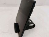 a black tablet computer on a stand on a white surface